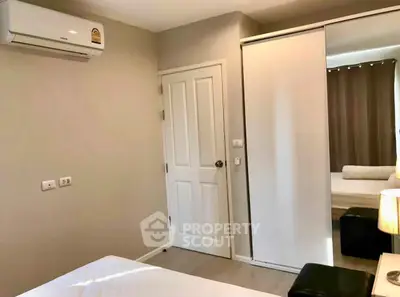 Modern bedroom with air conditioning and sliding closet doors, perfect for comfort and style.