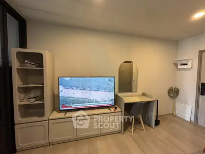 Modern living room with sleek furniture and TV, perfect for cozy relaxation.