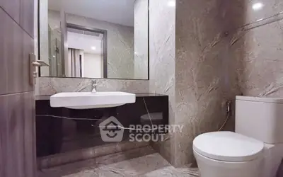 Luxurious modern bathroom with elegant marble finishes and sleek fixtures.