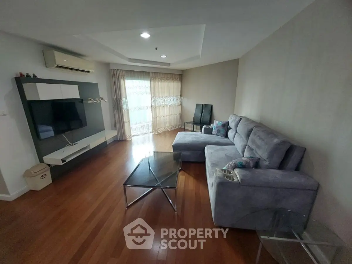 Spacious living room with modern furniture and large windows for natural light.