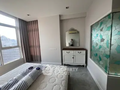 Spacious bedroom with city view and stylish decor in modern apartment