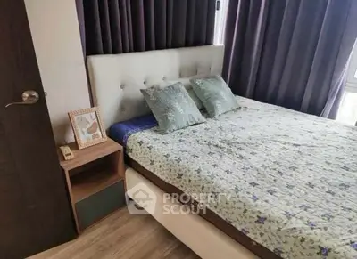 Cozy bedroom with elegant decor and plush bedding in modern apartment.