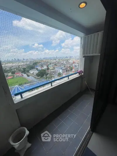 Spacious balcony with panoramic city view, perfect for relaxation and enjoying the skyline.
