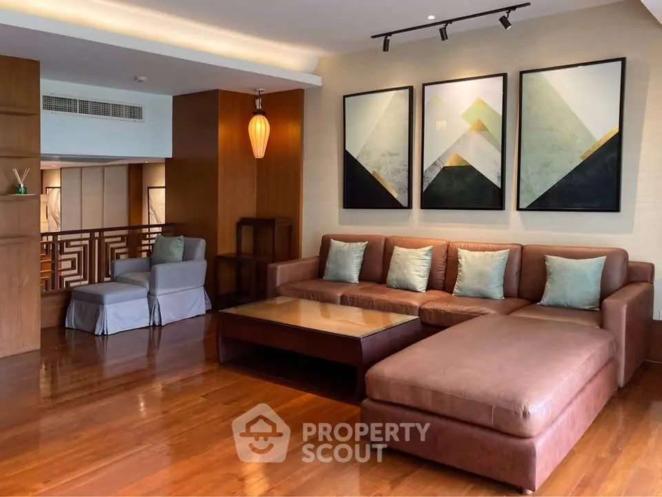 Luxurious living room with modern art and spacious seating in elegant apartment