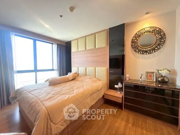 Luxurious bedroom with large window and elegant decor