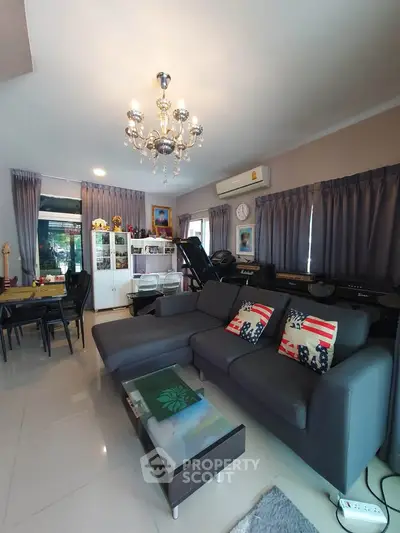Spacious living room with modern decor and elegant chandelier