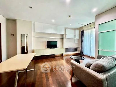 Spacious modern living room with hardwood floors and stylish furniture