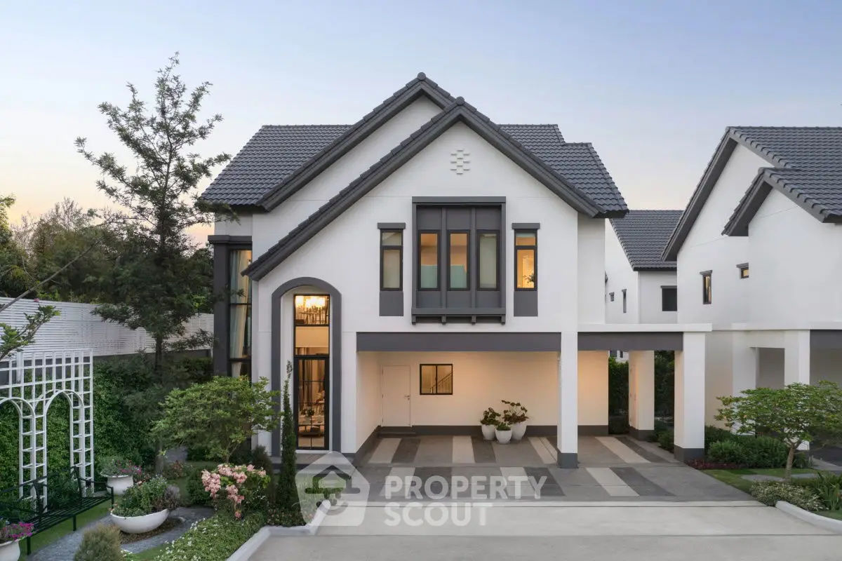 Elegant modern house with a spacious driveway and lush garden, perfect for family living.