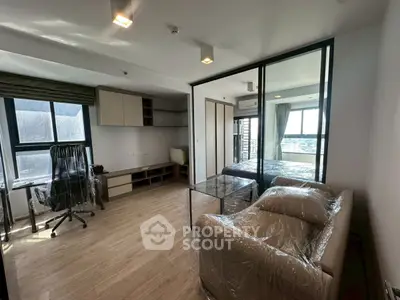 Modern living room with glass partition and natural light