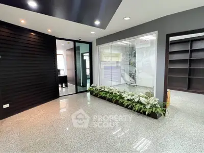 Modern office entrance with sleek design and indoor plants