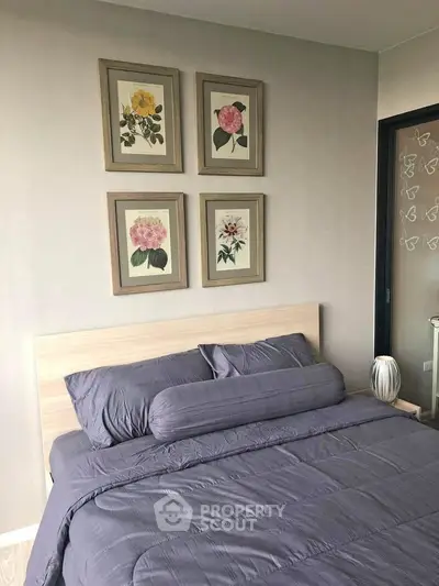 Cozy bedroom with elegant decor and floral artwork, perfect for relaxation and comfort.