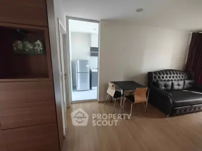 Modern apartment interior with cozy living area and kitchen view