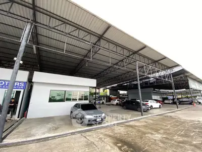 Spacious covered parking area with multiple cars and modern steel roofing.