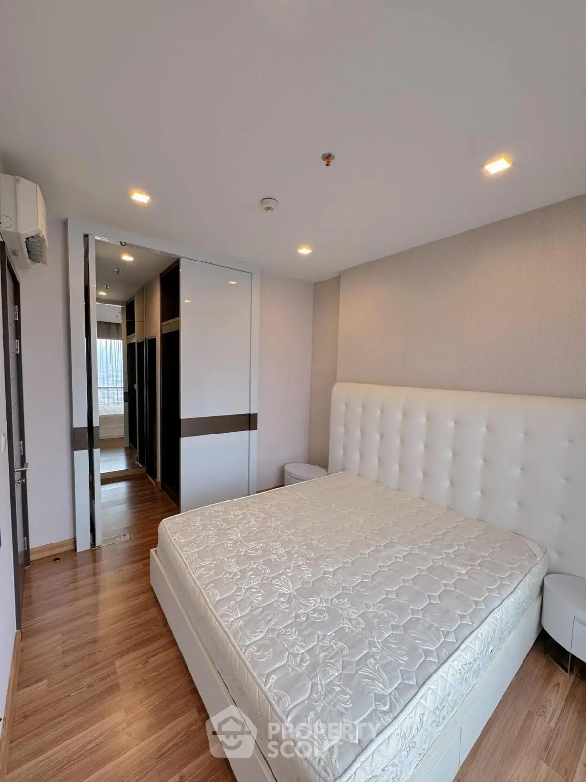 Spacious modern bedroom with elegant design and ample storage in a luxury apartment.