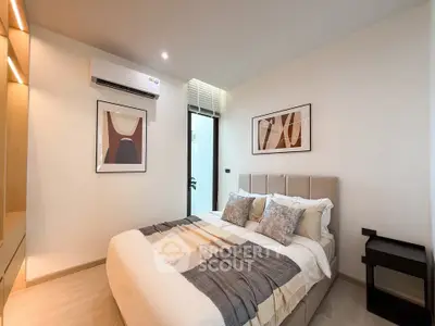 Modern bedroom with stylish decor and air conditioning in a cozy apartment.