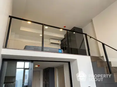 Modern loft apartment with sleek glass railing and spacious design