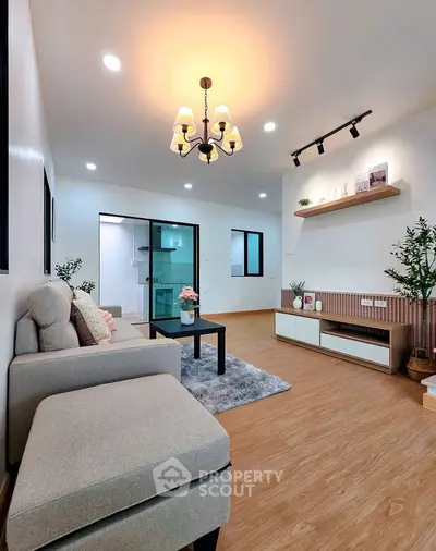 Modern living room with elegant chandelier and cozy seating area