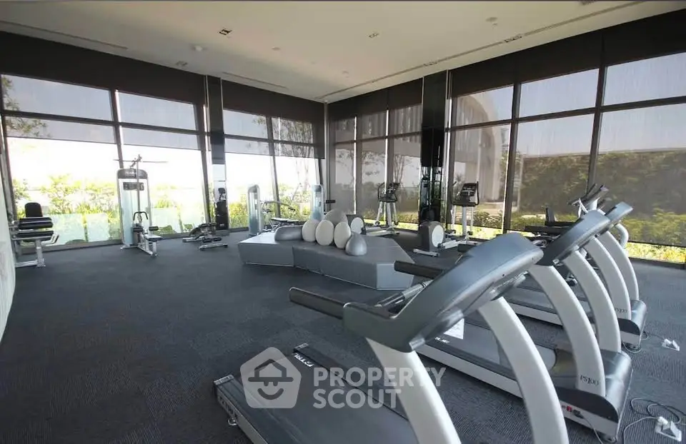 Modern gym with state-of-the-art equipment and scenic views, perfect for fitness enthusiasts.