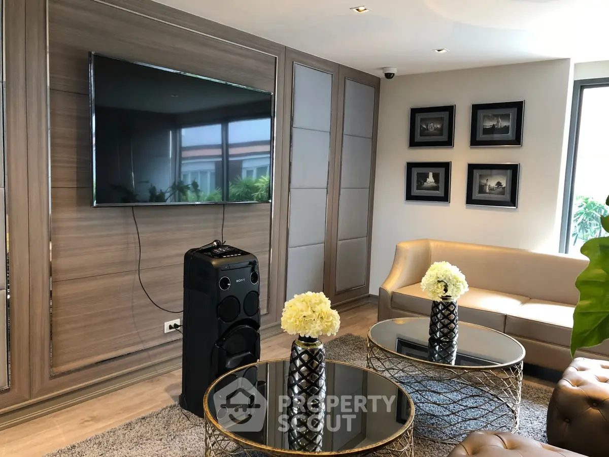 Luxurious living room with modern decor, large TV, and elegant furniture, perfect for relaxation and entertainment.