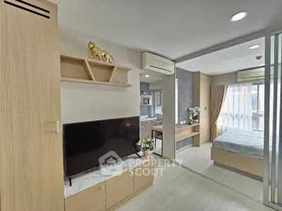 Modern apartment interior with open layout, featuring a cozy living area and stylish bedroom.