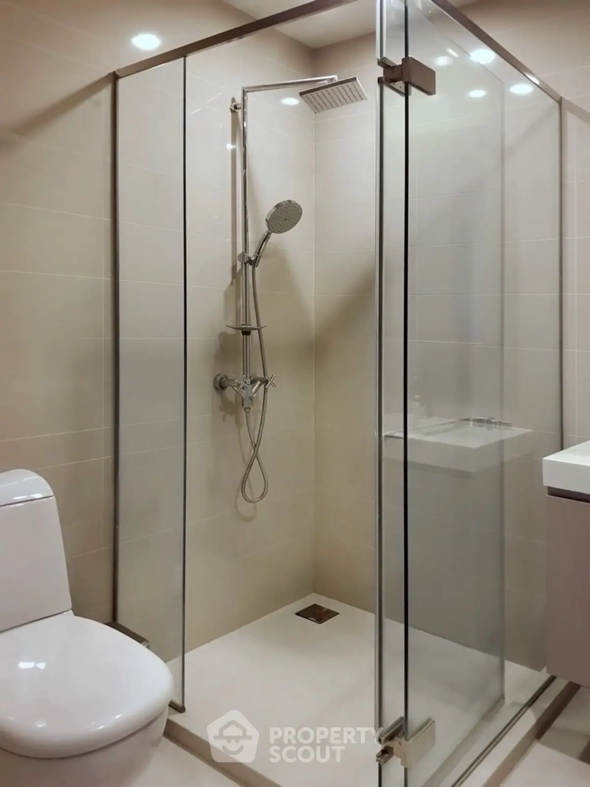 Modern bathroom with glass shower enclosure and sleek fixtures