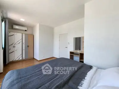 Spacious bedroom with modern wardrobe and cozy bedding in a bright apartment.