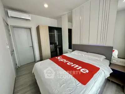Modern bedroom with stylish decor and air conditioning in a contemporary apartment.