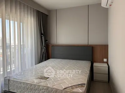 Modern bedroom with large window and stylish decor