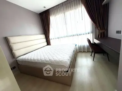 Modern bedroom with large window and elegant furnishings