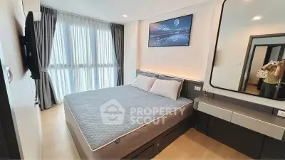 Modern bedroom with large window, stylish decor, and ample natural light.