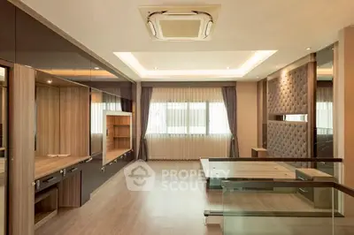 Luxurious modern living room with elegant wood finishes and ample natural light.