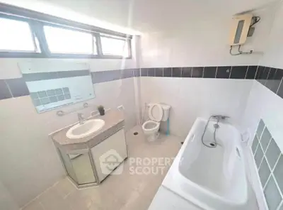 Bright bathroom with bathtub and modern fixtures in a real estate property.
