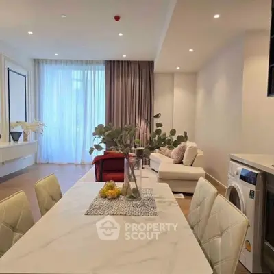 Modern open-plan living room with elegant dining area and natural light