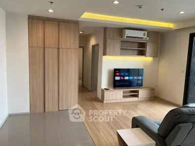 Modern living room with sleek wooden furniture and built-in TV unit