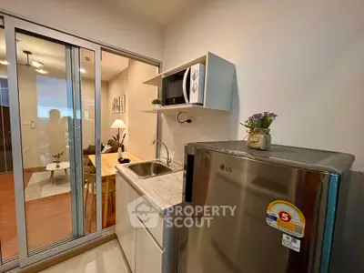 Modern compact kitchen with sleek appliances and open layout, perfect for urban living.