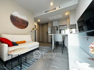 Modern living room with stylish decor and open kitchen layout in a contemporary apartment.