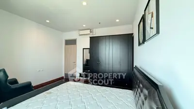 Spacious bedroom with modern furnishings and ample natural light.