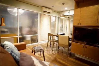 Stylish modern living room with open layout and elegant wooden furniture.