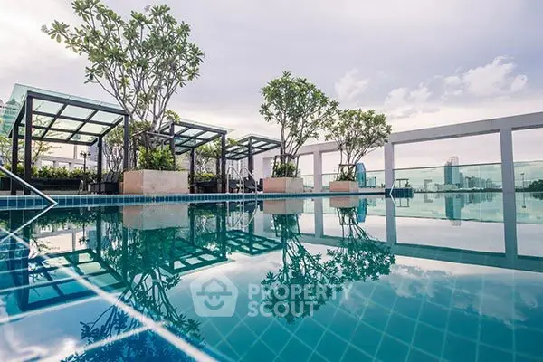 Stunning rooftop pool with city views and lush greenery in a modern urban setting.