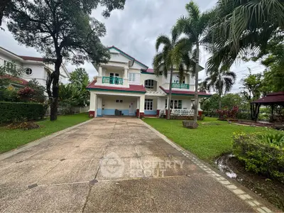 Stunning two-story house with lush garden and spacious driveway in a serene neighborhood.