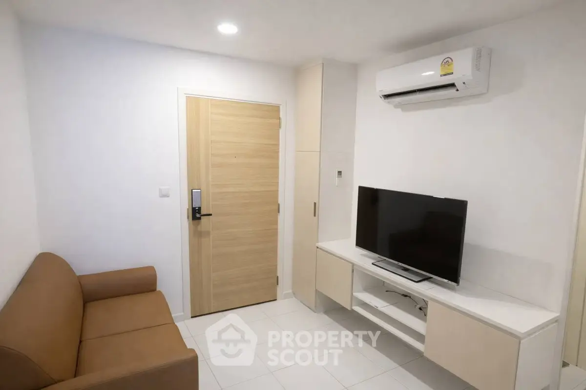 Modern living room with sleek furniture and air conditioning unit