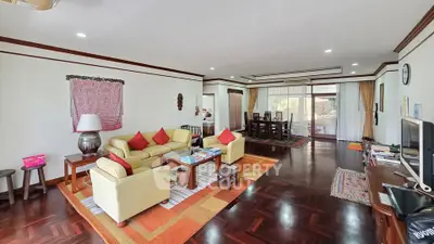 Spacious living room with elegant hardwood floors and stylish decor in a modern home.