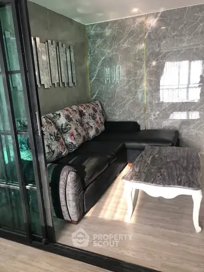 Stylish living room with modern decor and elegant marble wall accents.