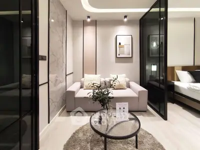 Modern living room with stylish decor and glass partitions in a luxury apartment.
