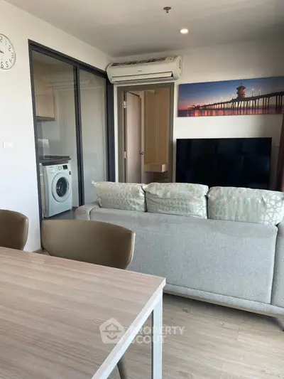 Modern living room with stylish decor and washing machine in view