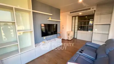 Modern living room with sleek built-in shelves and cozy seating area.