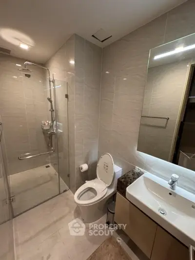 Modern bathroom with glass shower and sleek fixtures