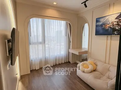 Chic modern living room with cozy sofa and large window offering city views, perfect for relaxation.