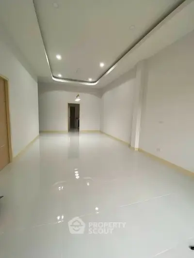 Spacious modern living room with sleek lighting and glossy tile flooring