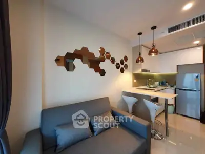 Modern living room with stylish decor and open kitchen layout in a cozy apartment.